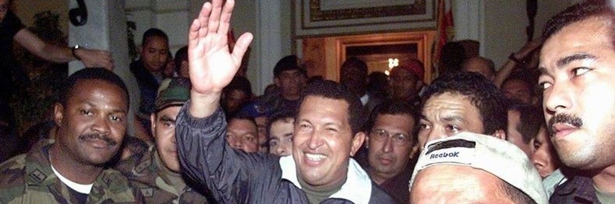 Hugo Chavez being returned to power on April13,  2002 after a right-wing coup briefly overthrew him.