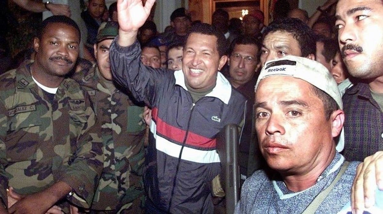 Hugo Chavez being returned to power on April13,  2002 after a right-wing coup briefly overthrew him.