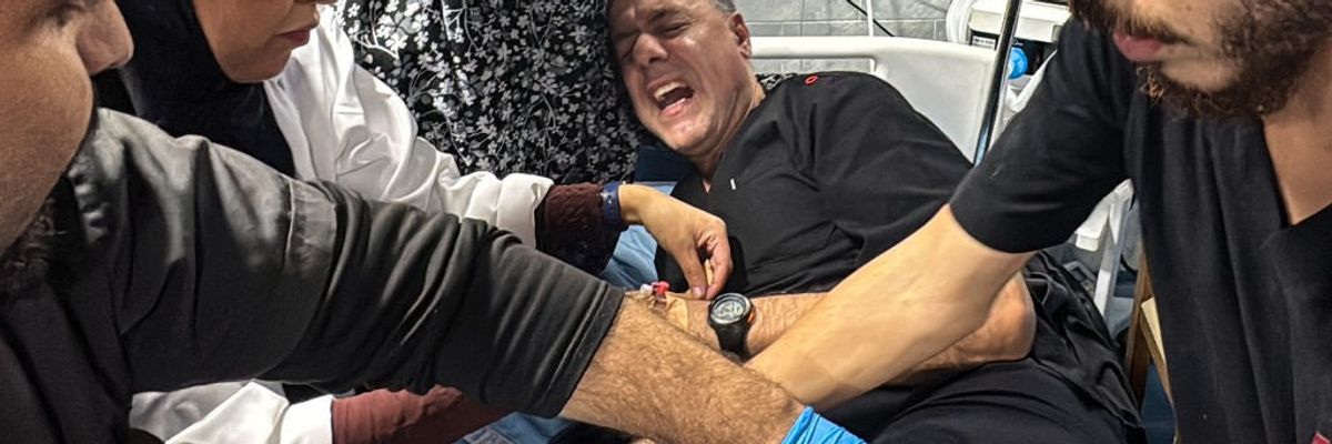 Hussam Abu Safiyeh, director of the Kamal Adwan Hospital, is treated by colleagues