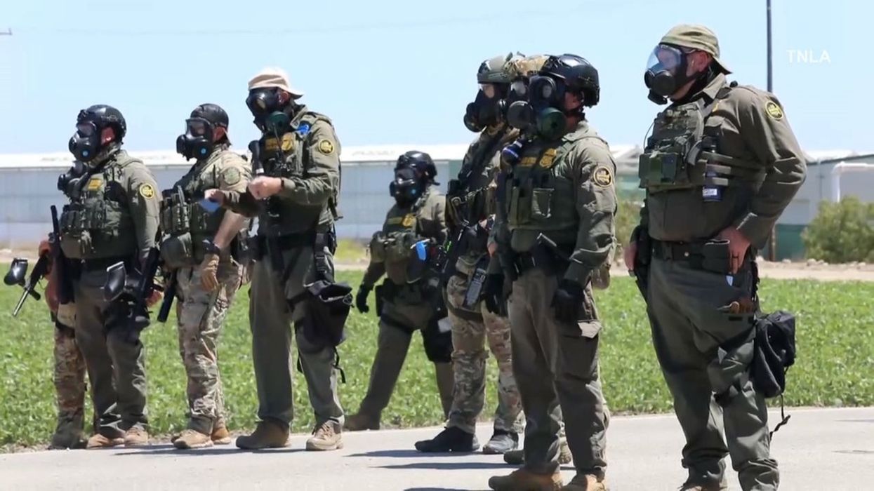 ICE agents in a field.