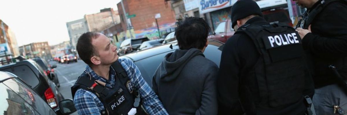 ICE officers arrest an undocumented Mexican immigrant during a raid in the Bushwick neighborhood of Brooklyn