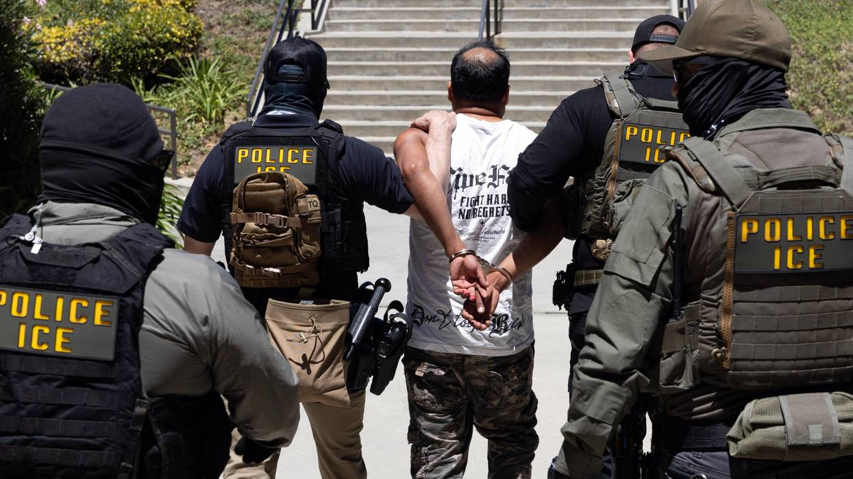 ICE officers with a detainee.