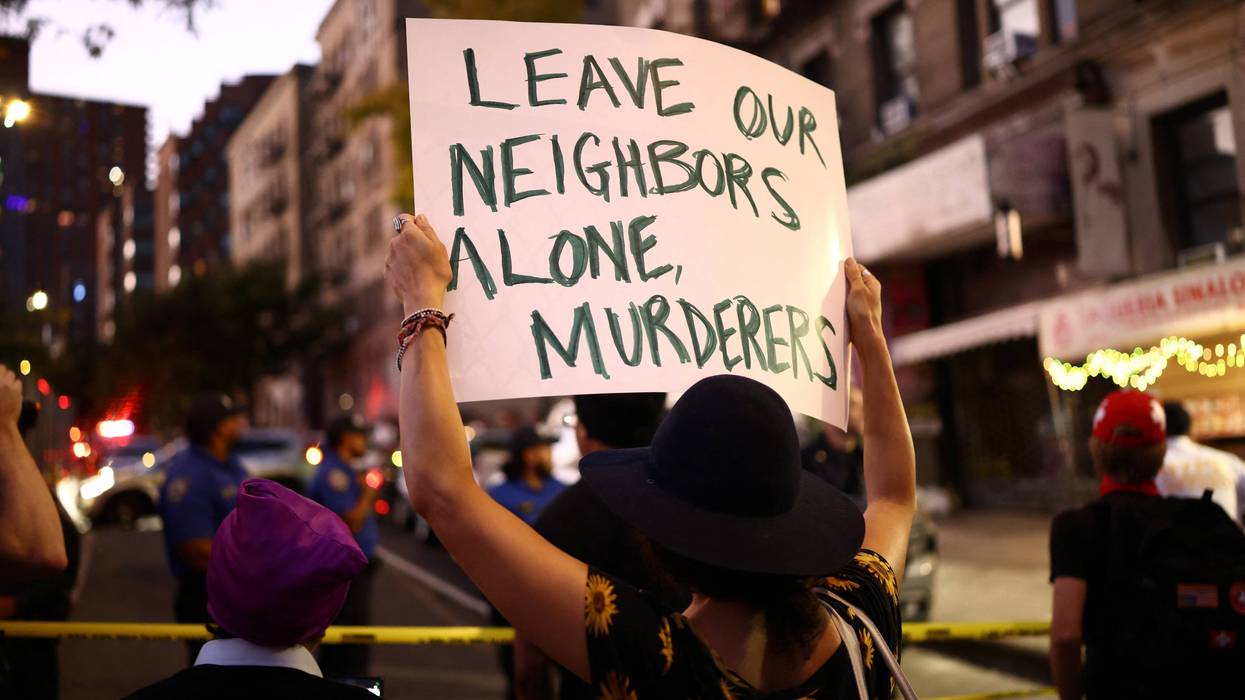 ICE protest "Leave our neighbors alone, murderers," sign says
