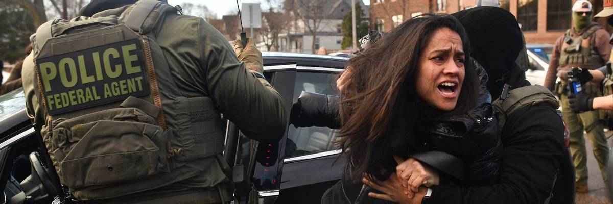 ICE remove woman from car.