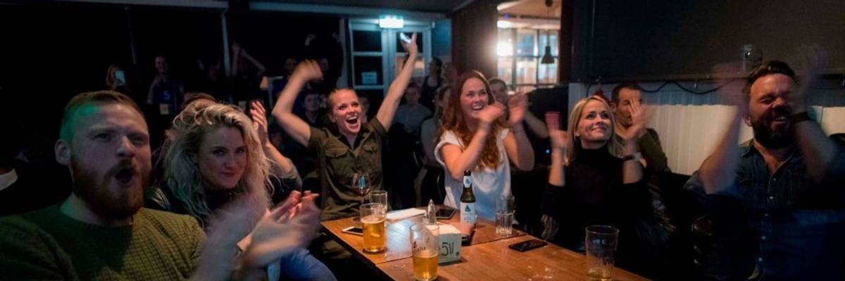 Icelandic people cheer while watching a football match