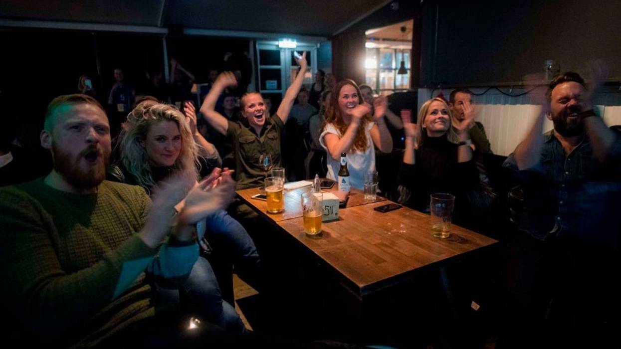 Icelandic people cheer while watching a football match