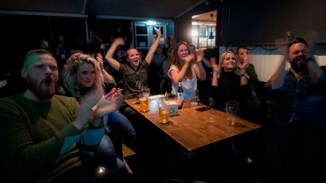 Icelandic people cheer while watching a football match