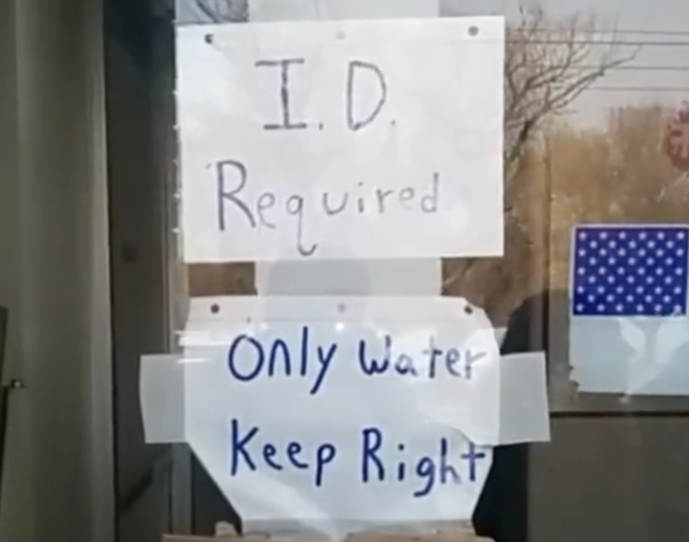 ID required sign at Flint water distribution center (courtesy Nayyirah Shariff)