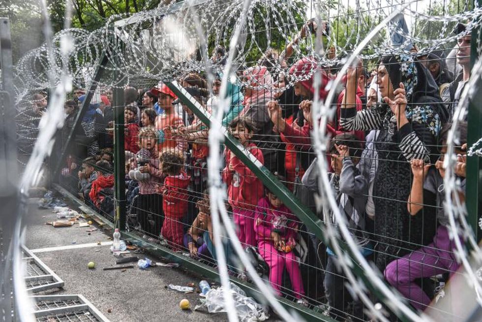 Image: Refugees behind the fence at the Hungarian border with Serbia on Sept. 16, 2015.