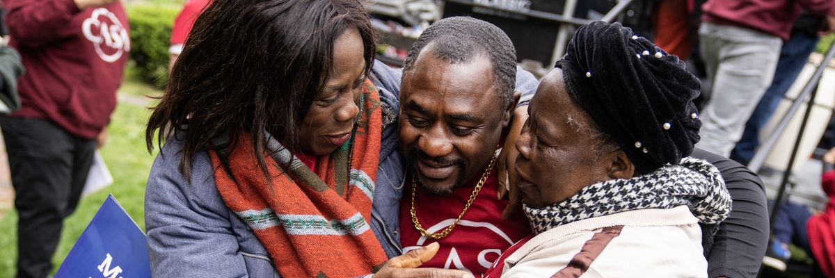 Immigrants embrace after rally for Temporary Protected Status.