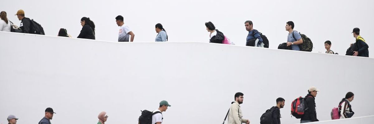 Immigrants in line at U.S. and Mexican border. 