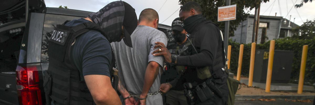 Immigration and Customs Enforcement agents apprehend an undocumented immigrant