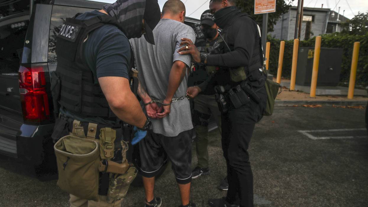 Immigration and Customs Enforcement agents apprehend an undocumented immigrant