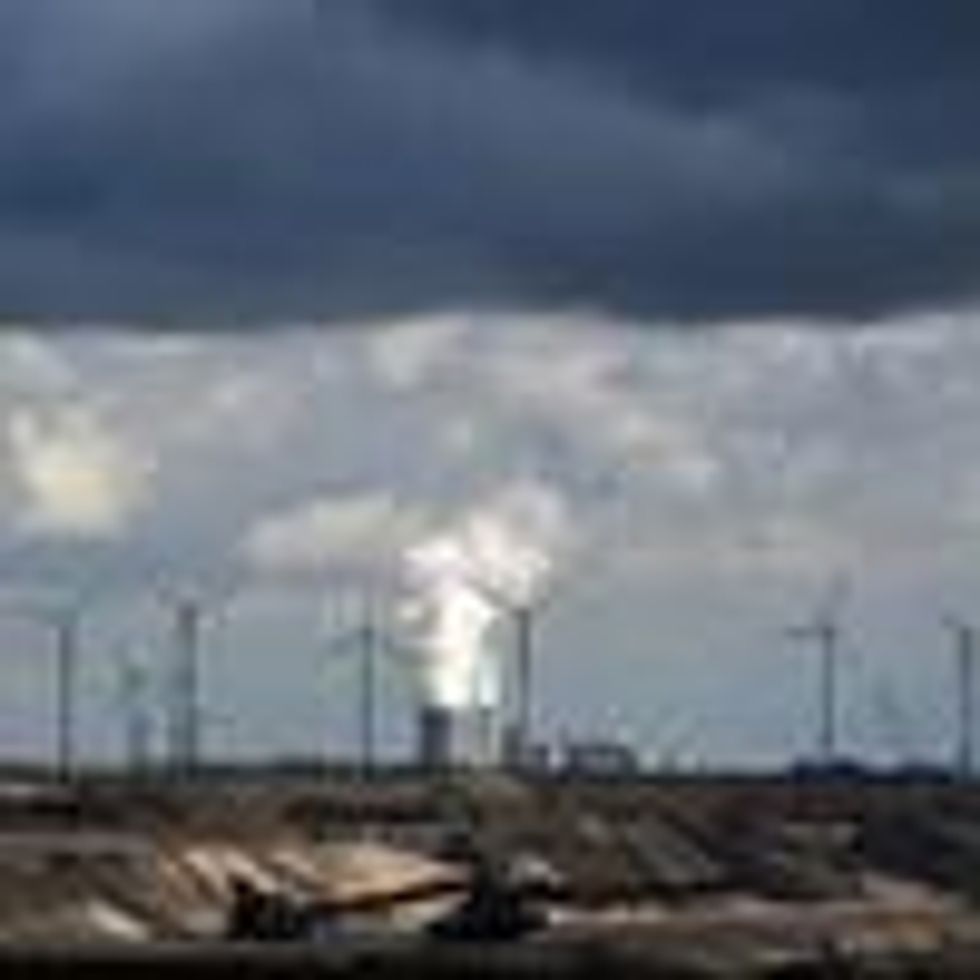In Garzweiler, Germany, wind turbines are seen near an open-cast mining operation and a coal-fired power plant run by German energy giant RWE on March 15, 2021.