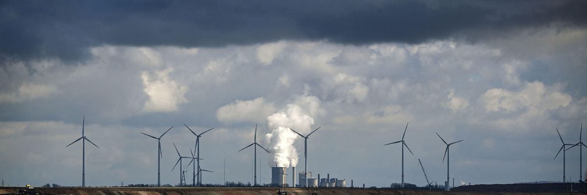 In Garzweiler, Germany, wind turbines are seen near an open-cast mining operation and a coal-fired power plant run by German energy giant RWE on March 15, 2021.