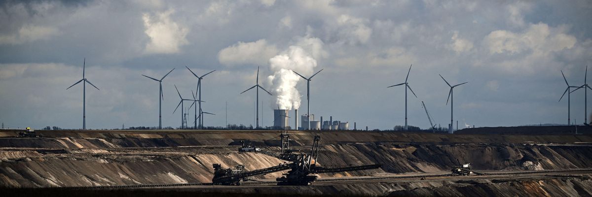 In Garzweiler, Germany, wind turbines are seen near an open-cast mining operation and a coal-fired power plant run by German energy giant RWE on March 15, 2021.