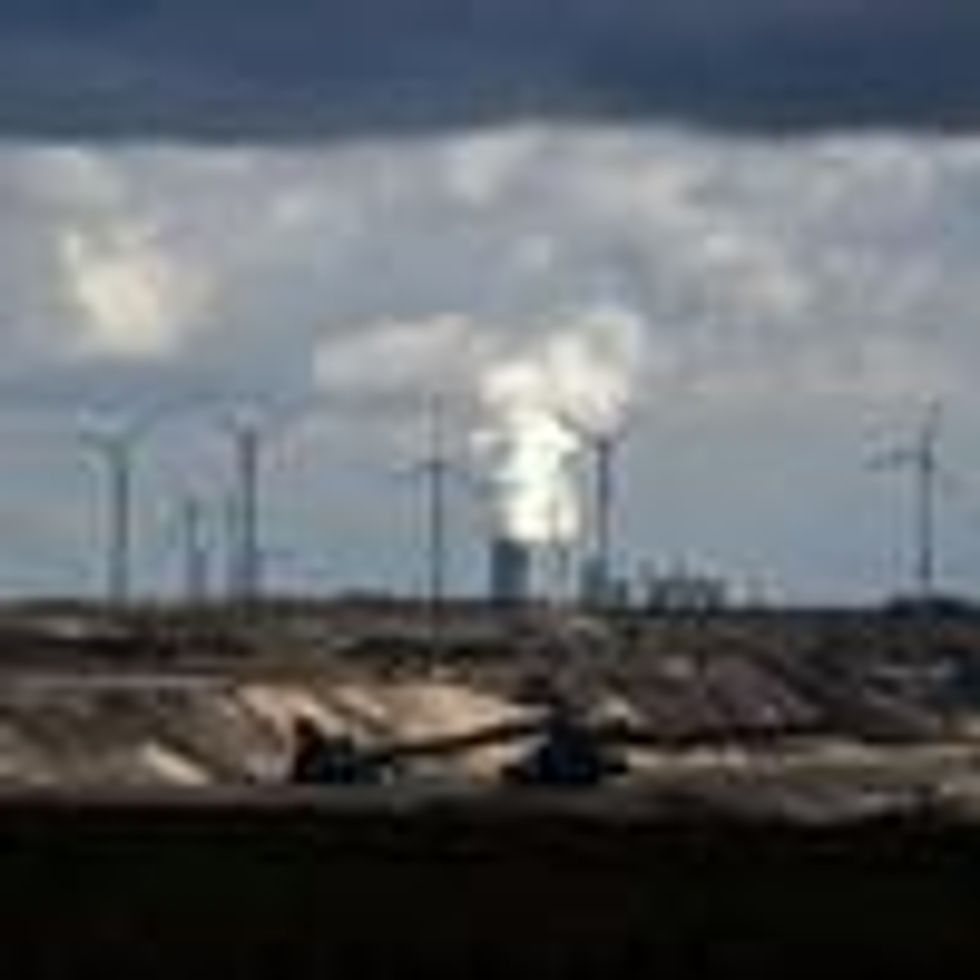 In Garzweiler, Germany, wind turbines are seen near an open-cast mining operation and a coal-fired power plant run by German energy giant RWE on March 15, 2021. (Photo: Ina Fassbender/AFP via Getty Images)