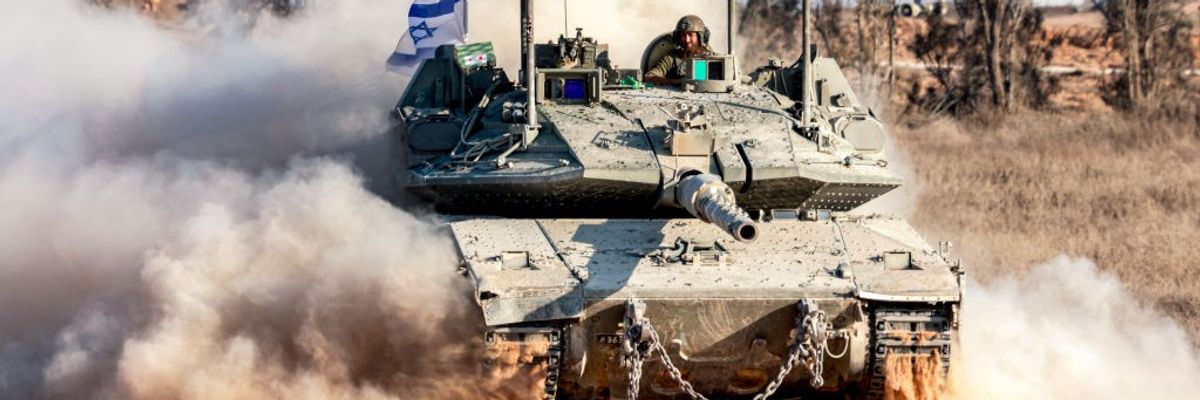 In Israeli Defense Forces tank rumbles along, kicking up dust as a soldier peers out of the turret.