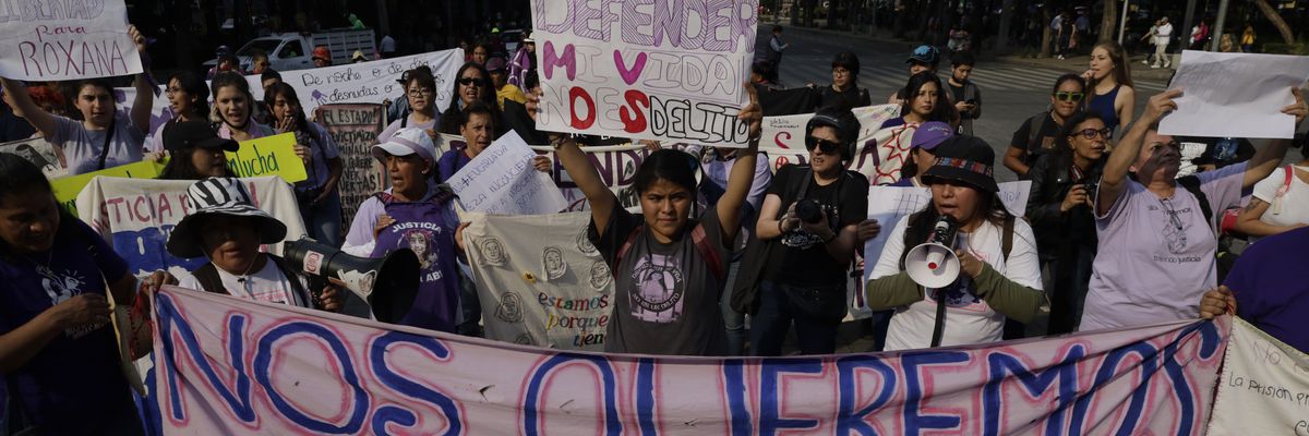 In the center, Roxana Ruiz, an Indigenous rape victim, holds a banner as she marches on Paseo de la Reforma Avenue in Mexico City on May 19, 2023 to demand justice after she was sentenced to six years and two months in prison for killing the man who raped her and threatened to kill her in her home in Ciudad Nezahualcoyotl, Mexico. ​