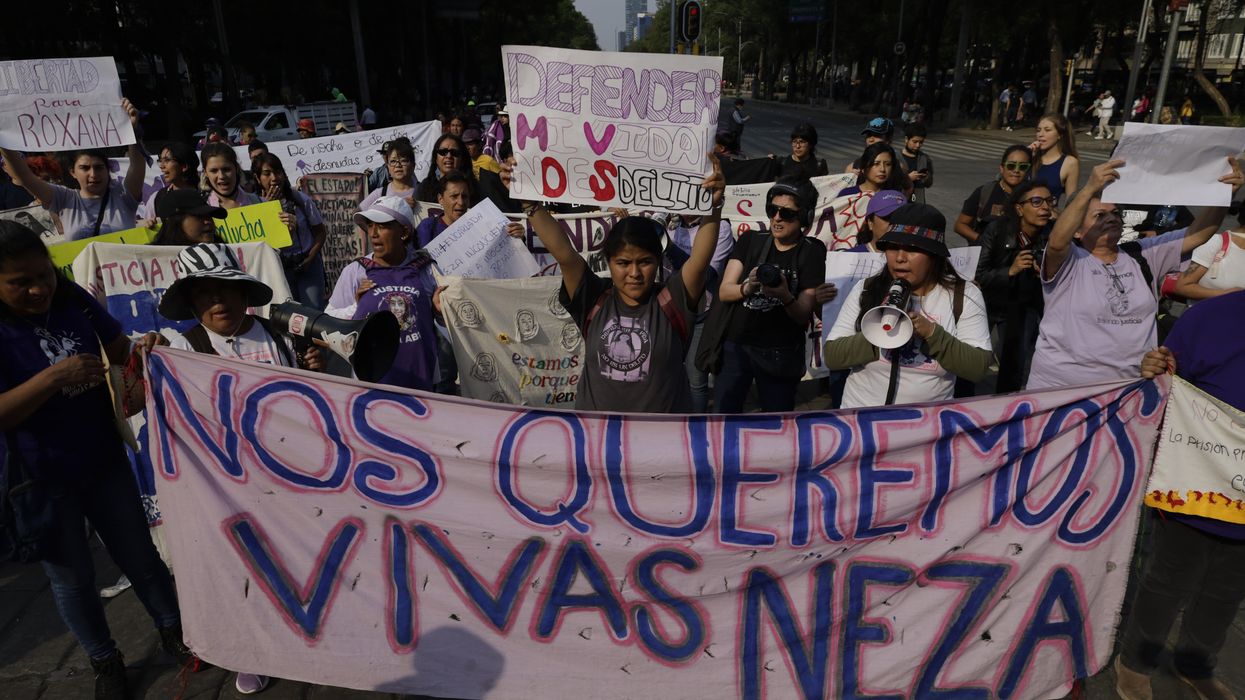 In the center, Roxana Ruiz, an Indigenous rape victim, holds a banner as she marches on Paseo de la Reforma Avenue in Mexico City on May 19, 2023 to demand justice after she was sentenced to six years and two months in prison for killing the man who raped her and threatened to kill her in her home in Ciudad Nezahualcoyotl, Mexico. 