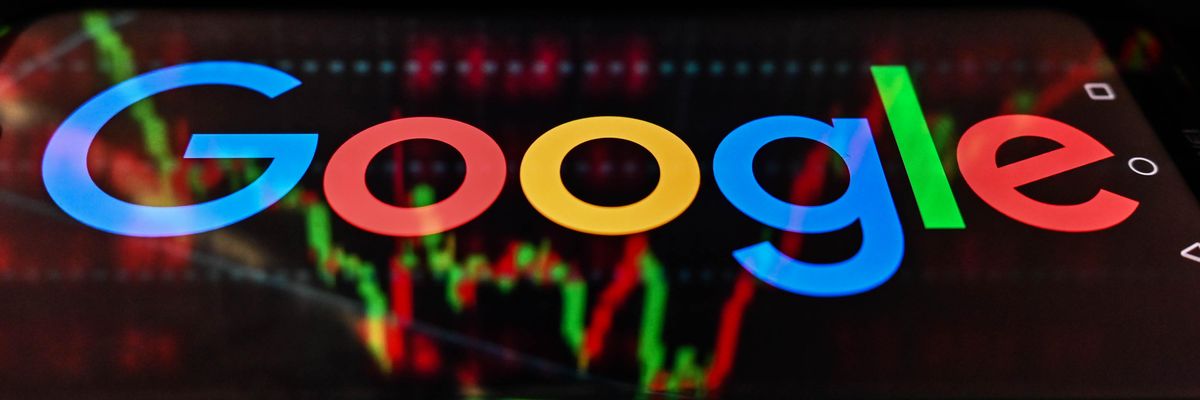 In this photo illustration, the Google logo seen displayed on a smartphone with stock market exchange in the background.