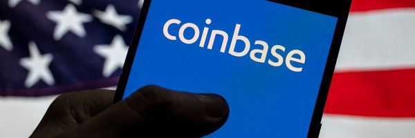 In this photo illustration, the logo of Coinbase, an online platform for buying, selling, transferring, and selling cryptocurrency, is seen on an Android device with the U.S. flag.