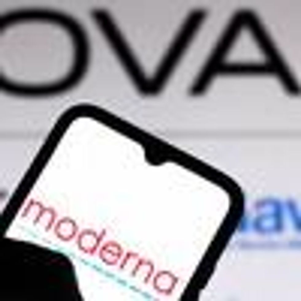In this photo illustration, the Moderna logo is seen displayed on a smartphone screen with the logo of Covax in the background.