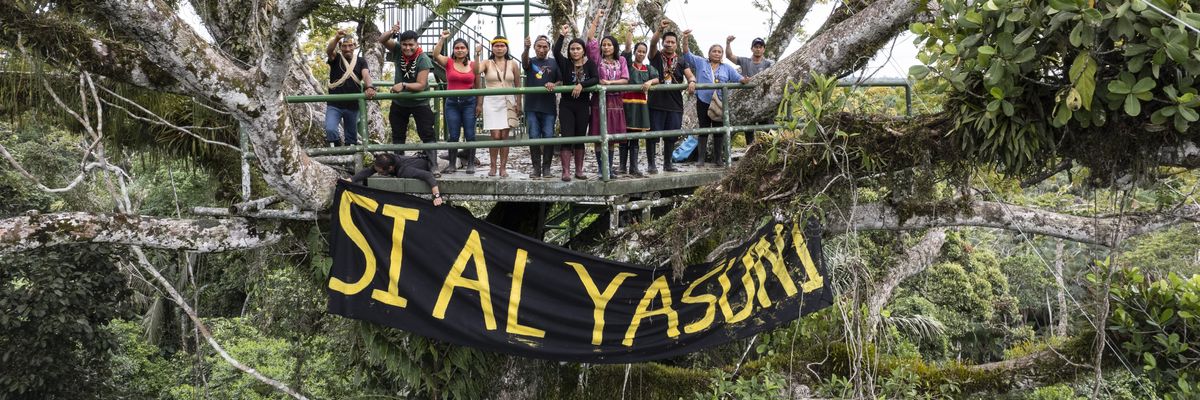 Indigenous activists with banners in Yasuni National Park