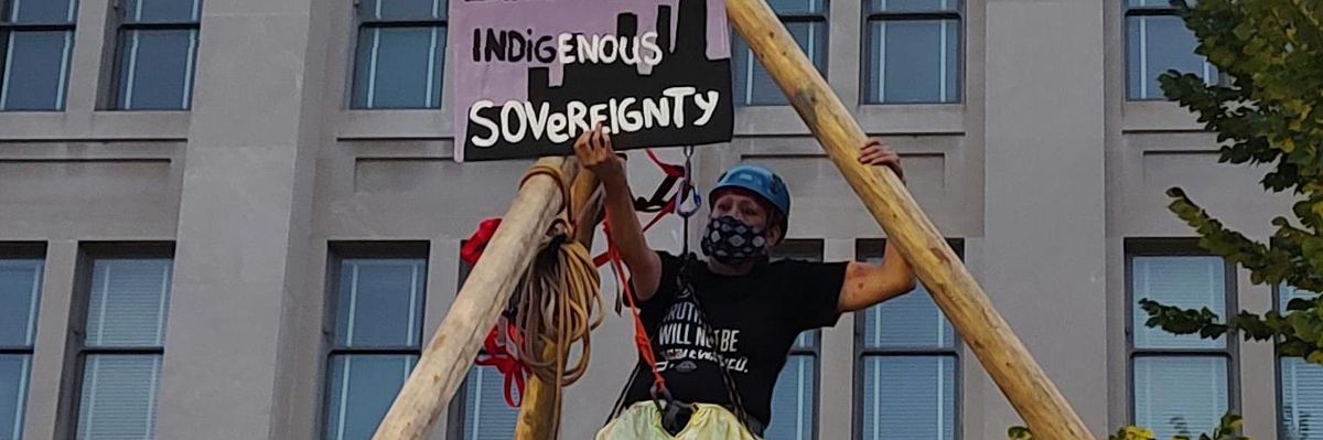 Indigenous demonstrators protest outside the Department of the Interior
