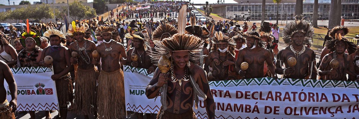 Indigenous protestors march towards the Supreme Court building in Brasilia