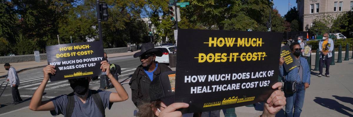 Individuals hold signs at a rally held by the Poor People's Campaign: A National Call For Moral Revival on October 27, 2021 in Washington, D.C. (Photo: Jemal Countess via Getty Images for Repairers Of The Breach)