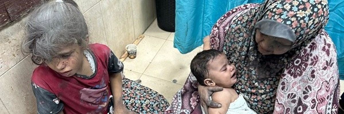 Injured Palestinians, including children, are taken to the Al-Shifa Hospital