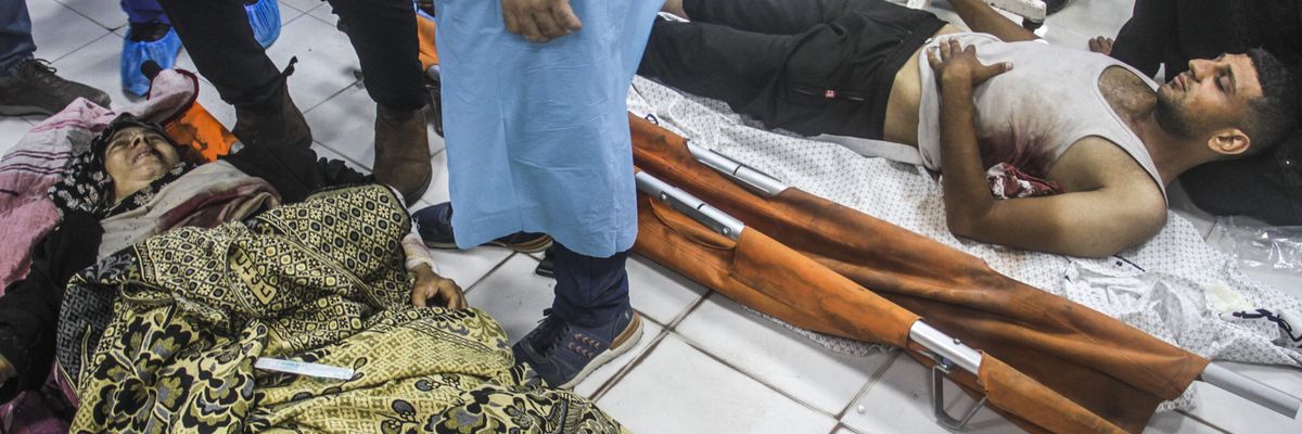 Injured Palestinians lay on the floor at Indonesian Hospital