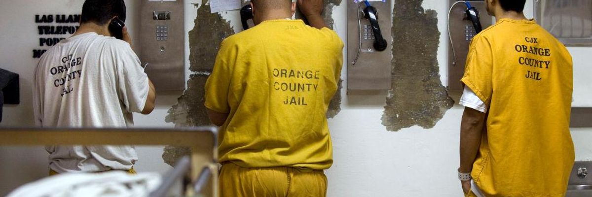 Inmates make collect phone calls at a jail in Santa Ana, California on May 24, 2011.