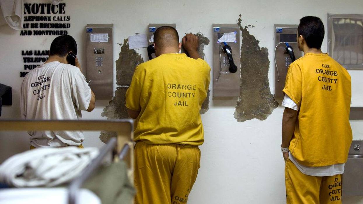 Inmates make collect phone calls at a jail in Santa Ana, California on May 24, 2011.