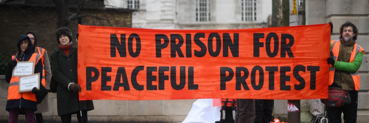 Insulate Britain supporters hold banners