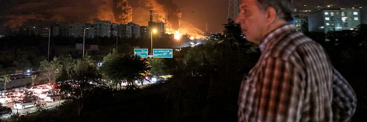 Iranian man watches traffic amid Israeli attacks