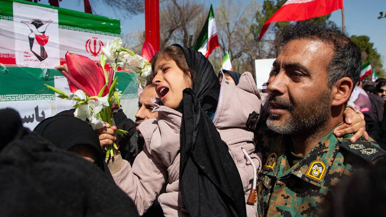 Iranian people mourn war dead.