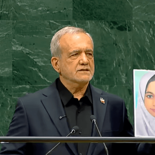 Iranian President Masoud Pezeshkian holds a photo of one of the 120 children killed in the Minab school strike