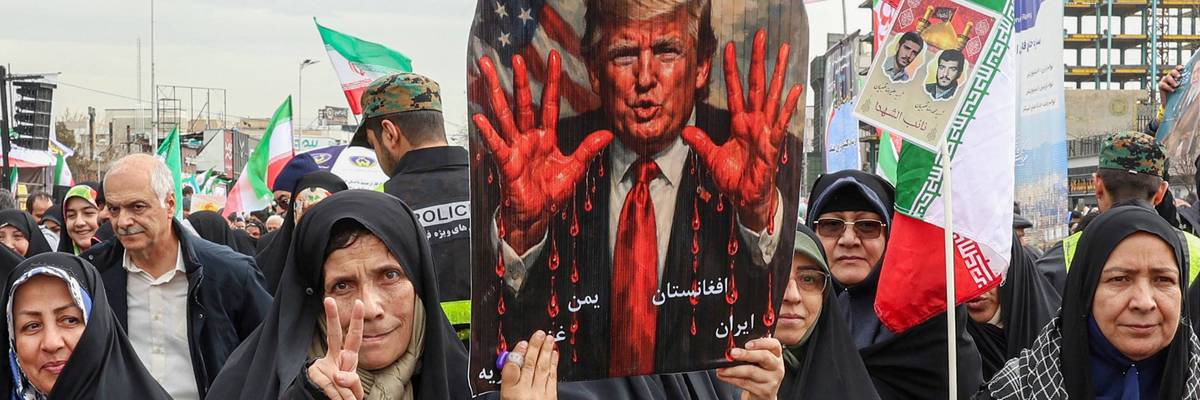 Iranians protest Trump, who is shown on a placard with bloody hands