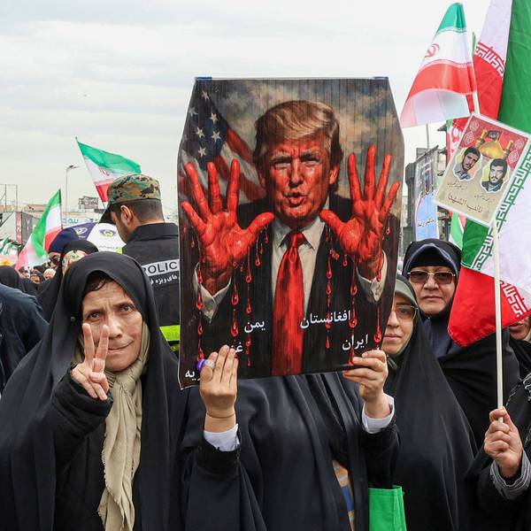 Iranians protest Trump, who is shown on a placard with bloody hands