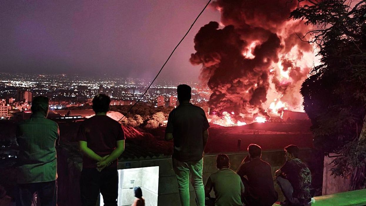 Iranians watch explosions from Israeli bombing of Tehran