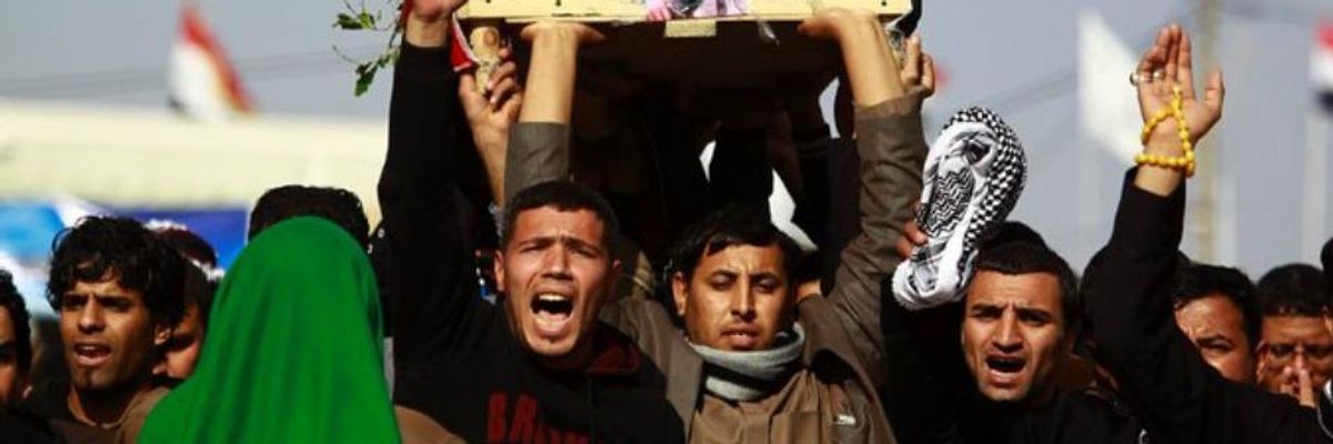 Iraqi mourners carried the body of one of the soldiers killed in the airstrike near Falluja