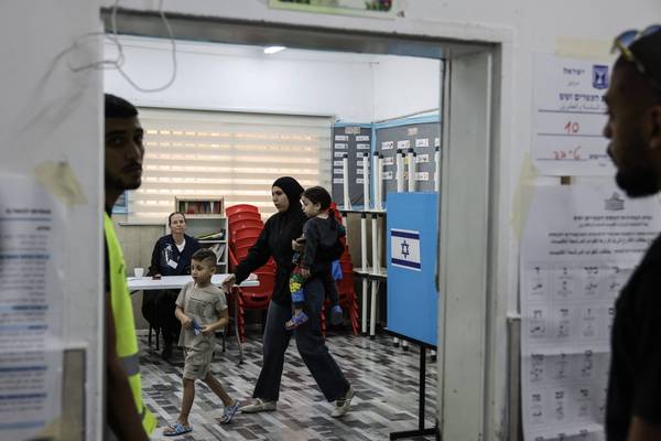 A woman prepares to cast her ballot for Israel's legislative election at a polling station in the predominantly-Arab city of Tayibe on October 27, 2026, on the day of Israel's legislative election