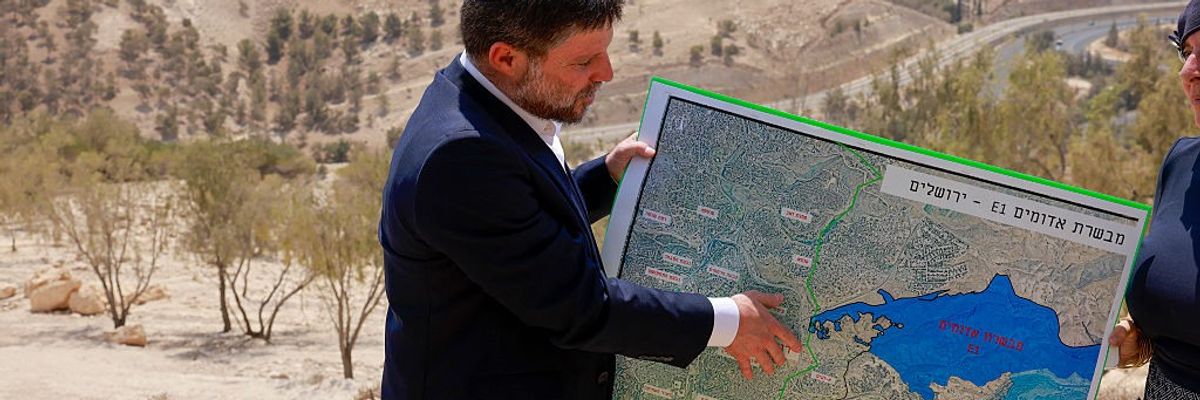 Israeli far-right Finance Minister Bezalel Smotrich holds a map of an area near the settlement of Maale Adumim