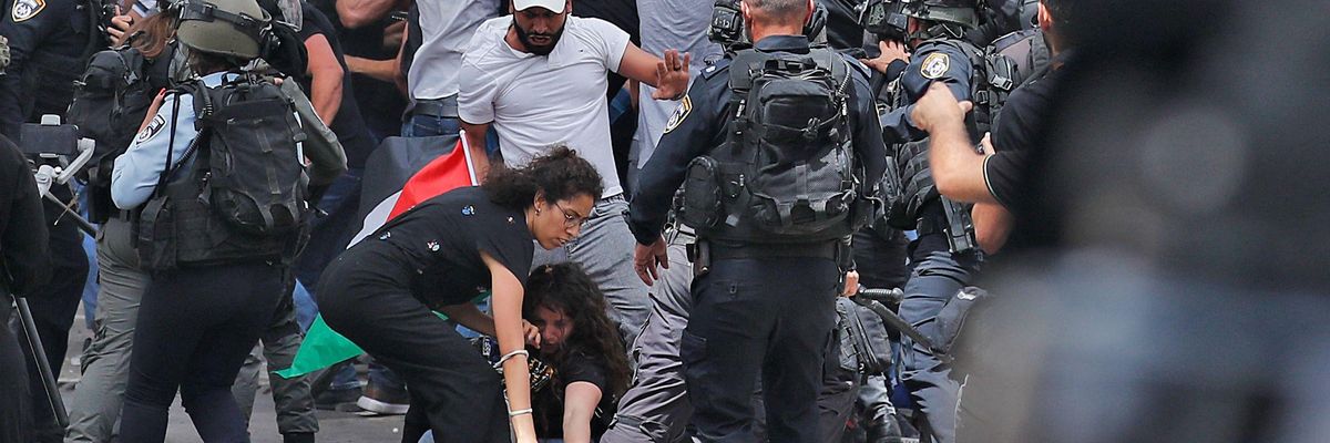 Israeli forces beat Palestinian mourners carrying the casket of slain Al Jazeera journalist Shireen Abu Akleh from a hospital in Jerusalem to her final resting place on May 13, 2022.