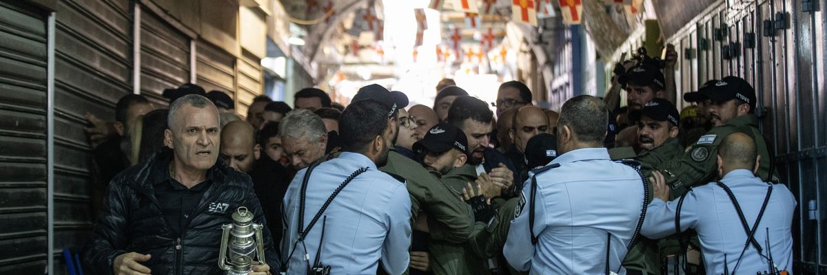 Israeli forces block the entrance of the Church of the Holy Sepulchre for the Orthodox Christians during the "Holy Fire" mass in East Jerusalem on April 15, 2023.