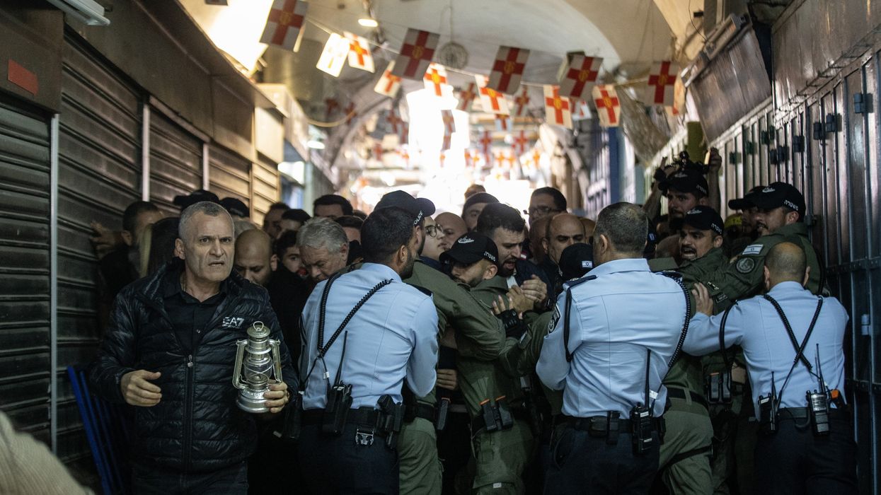 Israeli forces block the entrance of the Church of the Holy Sepulchre for the Orthodox Christians during the "Holy Fire" mass in East Jerusalem on April 15, 2023.