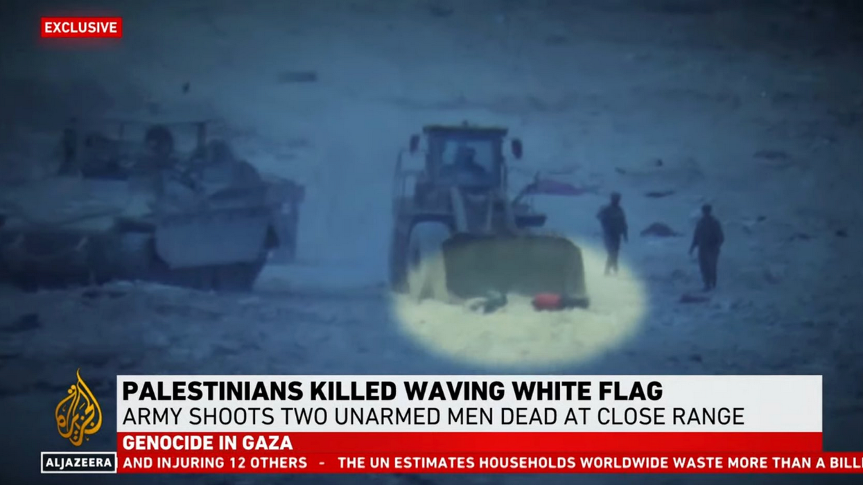 Israeli forces burying the bodies of two Palestinians with a bulldozer