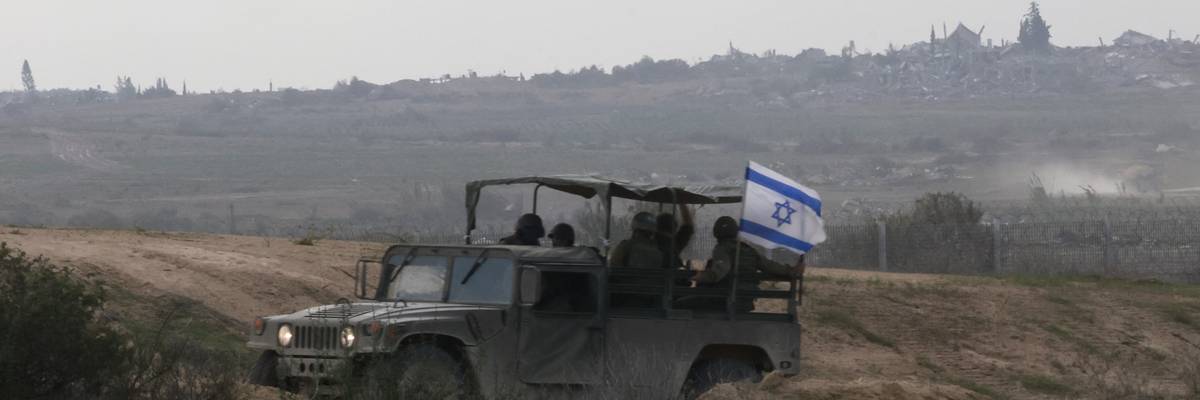 Israeli forces drive a military vehicle